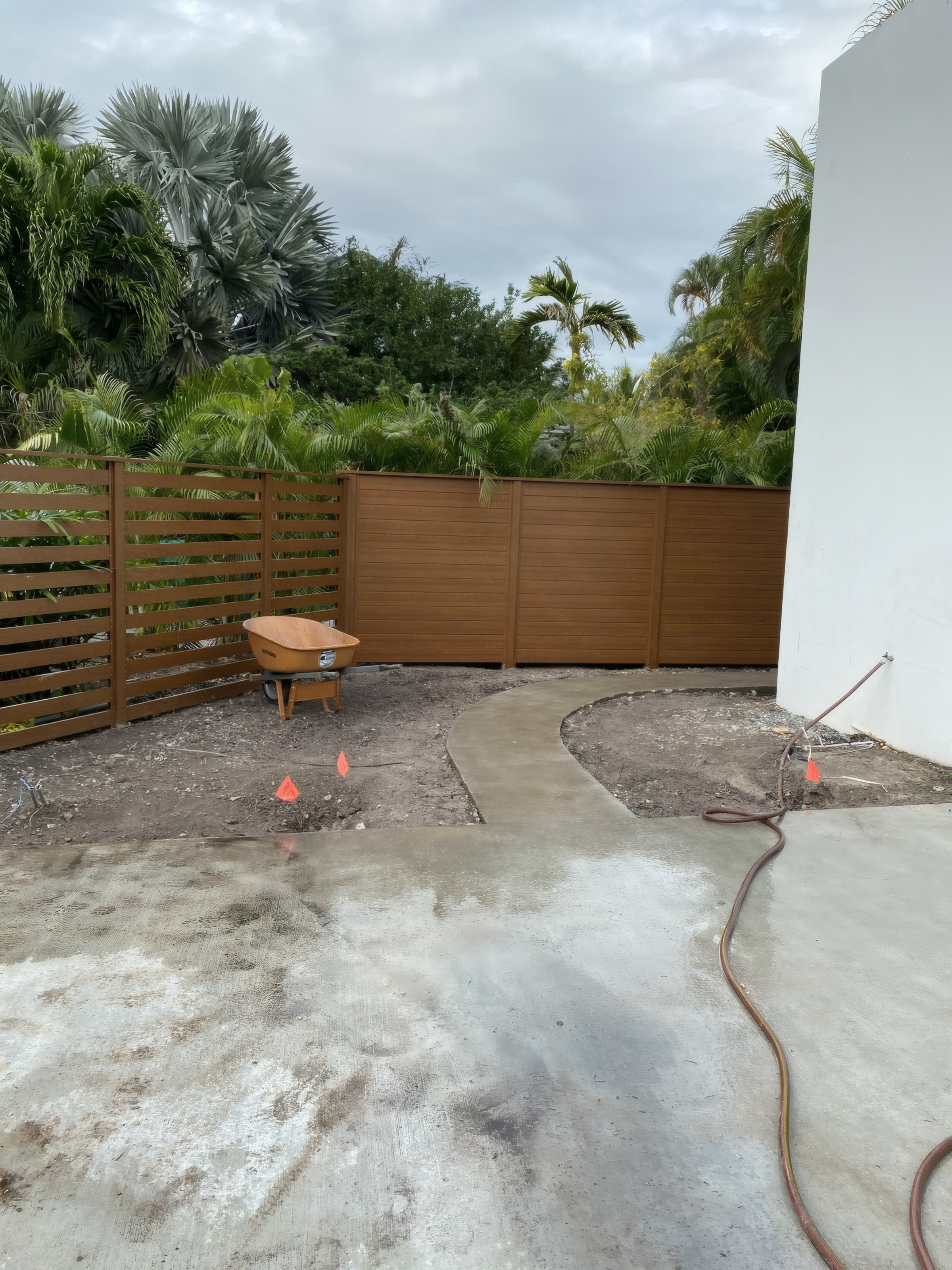 Before: bare concrete corner with construction materials